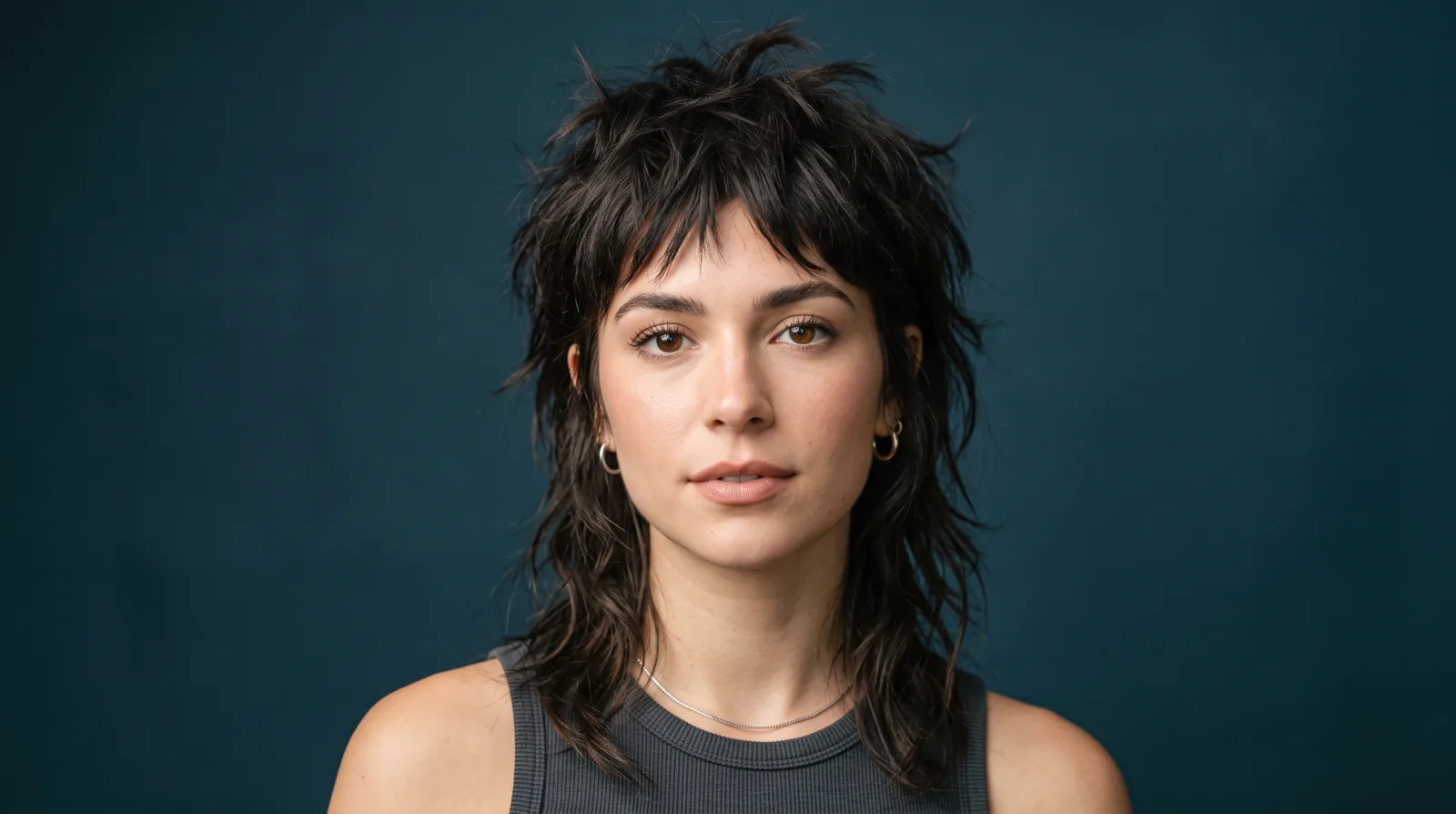 Flat illustration of a woman with a shaggy wolf cut, choppy layers on top and longer ends